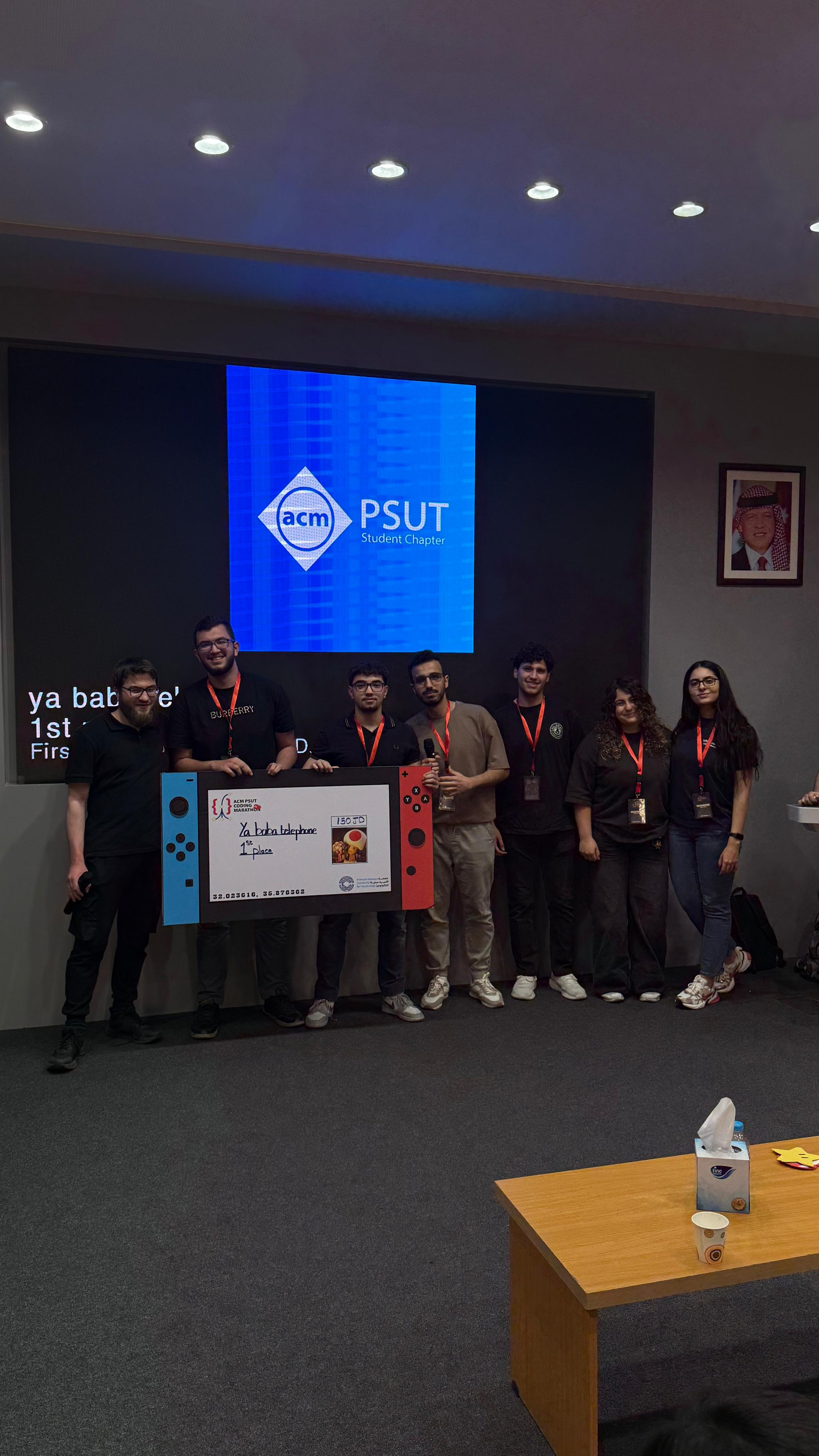 Winning team on stage holding the cheque