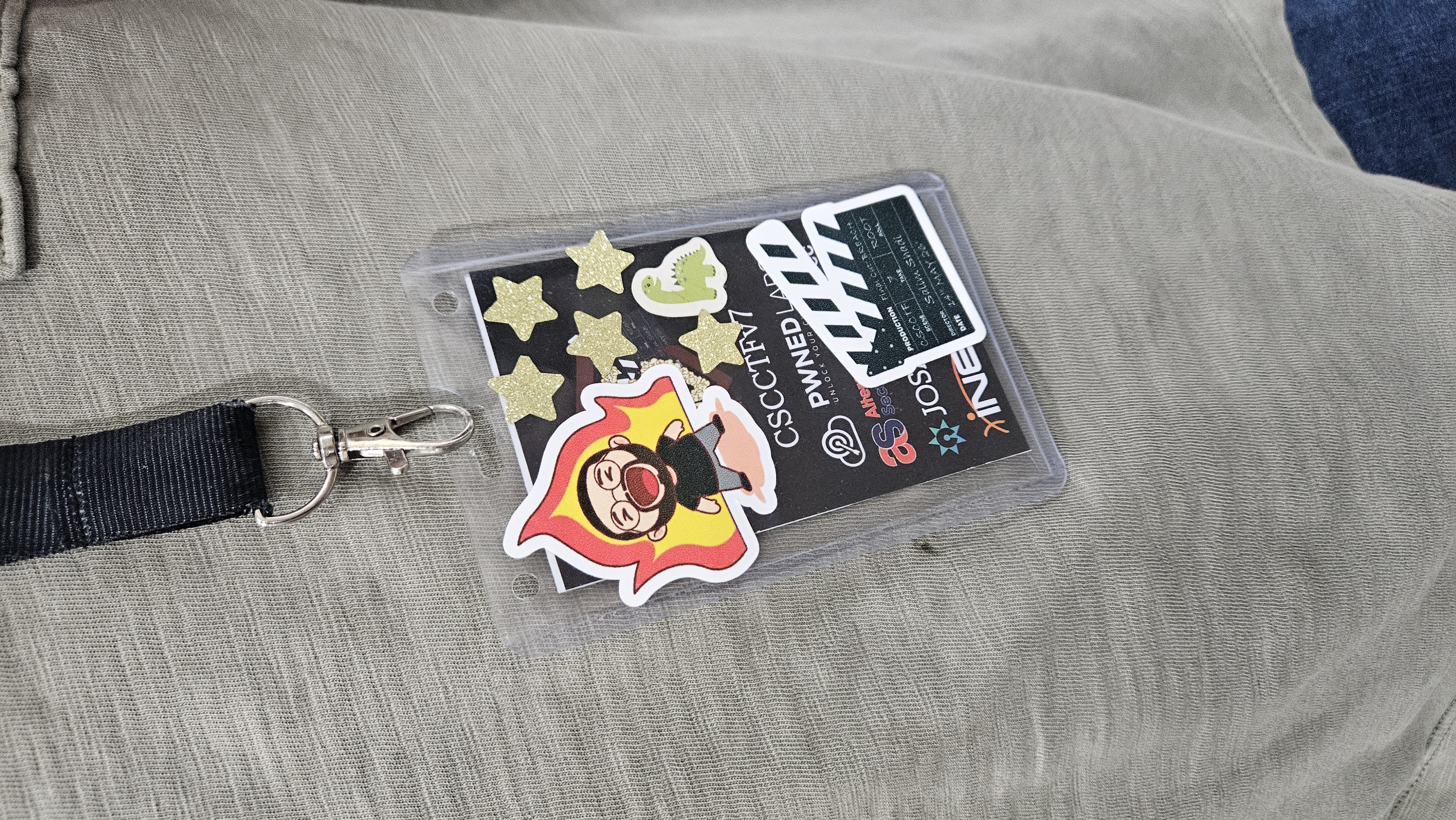 Event badge with stickers on a lanyard