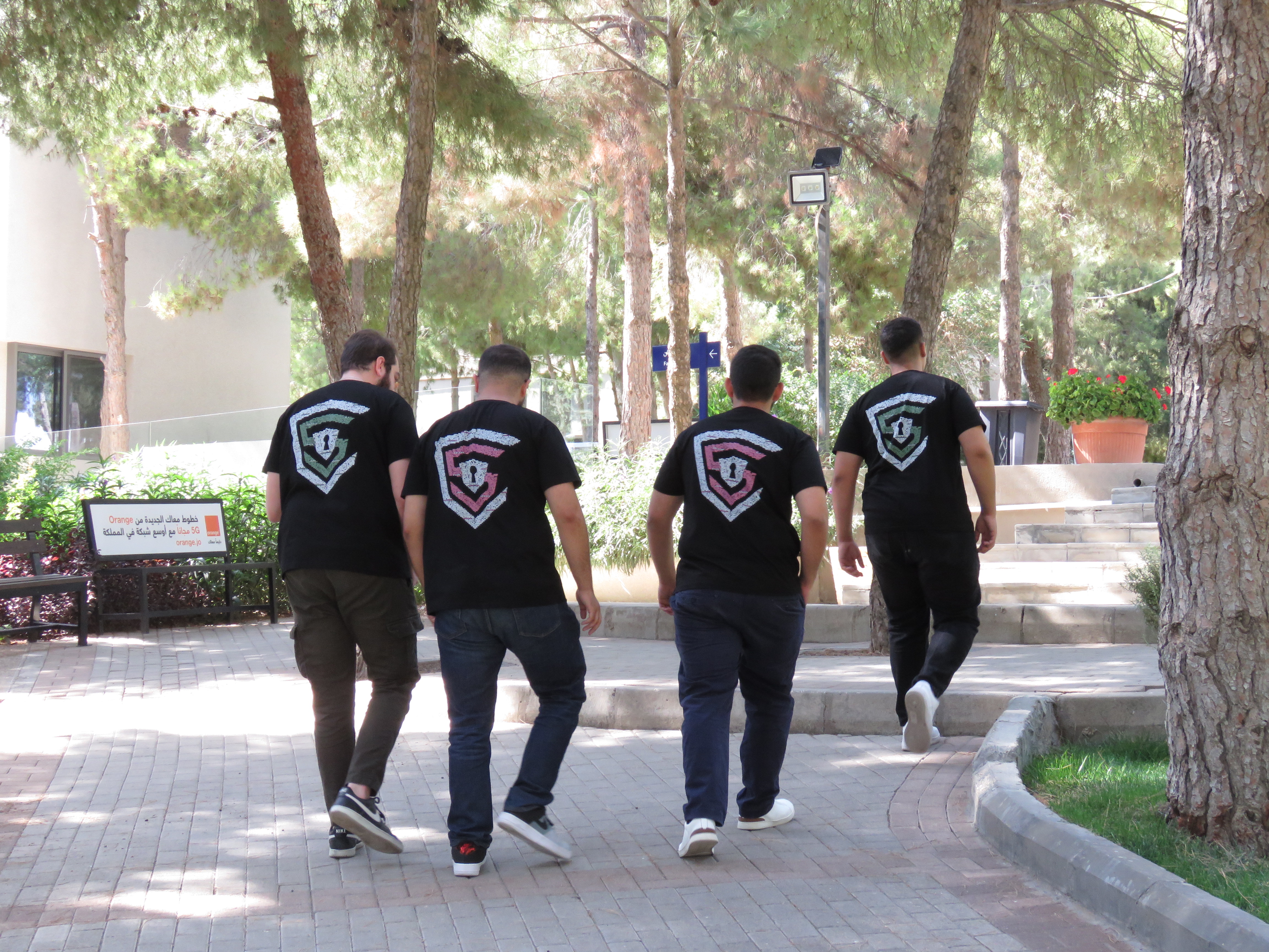 Club members walking on campus wearing the shirts